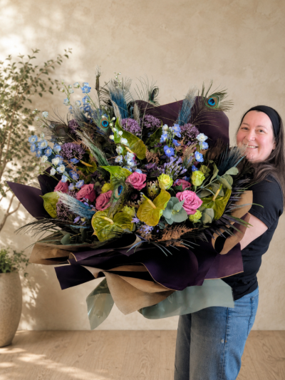 Peacock Wonder - Not for the faint-hearted! Peacock Wonder is one of Sarah's signature luxury creations, designed for those who believe bigger really is better. Featuring dramatic peacock feathers, exotic textures and an abundance of premium flowers, this spectacular bouquet is individually handcrafted to create maximum impact. Every design is unique, making it a true work of floral art.
