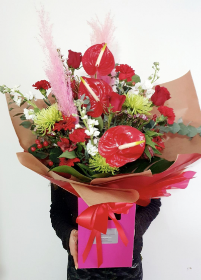 Tropical Love - A stunning handtied bouquet, delivered in water in a gift box, includes beautiful red anthuriums, red roses and other choice valentine flowers